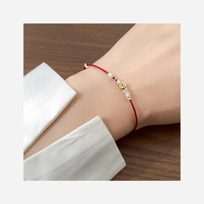 Pulseira charm vermelha com moedas douradas - Loja Simplicité