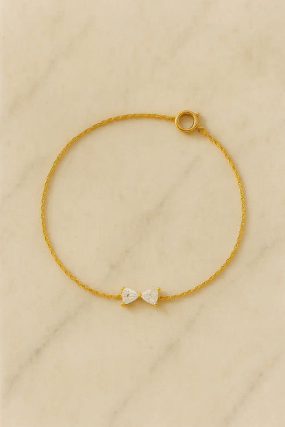 Pulseira minimalista pingente laço dourado sobre pedra natural clara